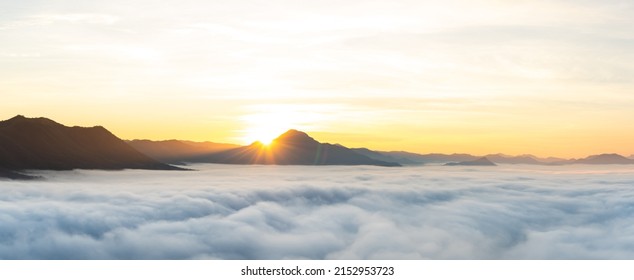 Panorama Views of Sunrise from behind the mountains above the Sea of Mist at Phu Thok, Chiang Khan, Thailand. - Powered by Shutterstock