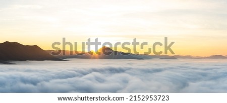 Panorama Views of Sunrise from behind the mountains above the Sea of Mist at Phu Thok, Chiang Khan, Thailand.