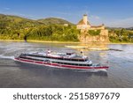 Panorama of Wachau Valley with castle Schonbuhel above the Danube River against tourist boat in Lower Austria, Austria.