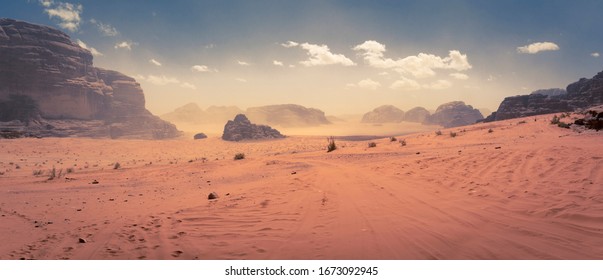 Panorama of the Wadi Rum desert in Jordan during a slight sand storm - Shutterstock ID 1673092945
