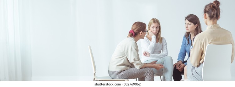 Panorama Of Women Sitting In Circle During Session With Psychologist