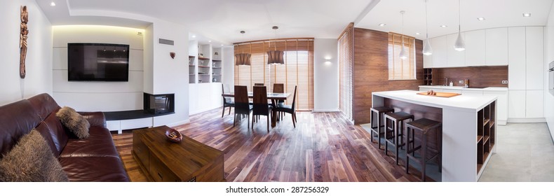 Panorama of wooden modern lounge connected with kitchen