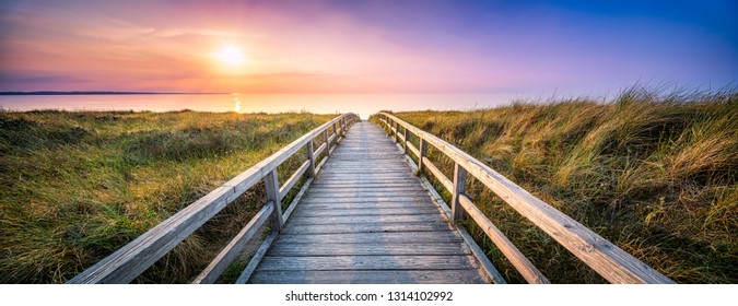 Panorama of a wooden pier along the dunes during sunset - Powered by Shutterstock