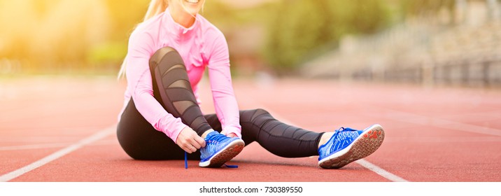 Panorama Of Young Attractive Woman Tying Shoelaces Before Or After Training Enjoying Time After Good Workout, Sun Flare, No Face Visible