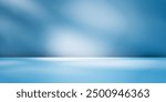 Panoramic abstract blue background for product presentation with sunlight and blurred shadows wall. Winter background.
