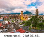 panoramic aerial drone view of the beautiful Catedral de Orizaba (San Miguel Arcángel) that decorates the streets of Orizaba on a cloudy day
