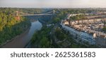 Panoramic aerial image of a sunrise over Bristol cityscape featuring the famous Clifton Suspension Bridge and River Avon. 