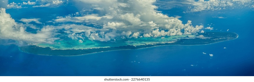 panoramic aerial landscape view of isolated Aldabra Island, Seychelles, located in the most southwestern part of Seychelles, part of Aldabra Group, partly covered with clouds 
