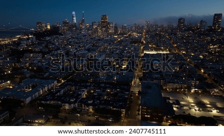 panoramic aerial night view of greater San Francisco area with illuminated skyline of SoMa and Financial District  in the background