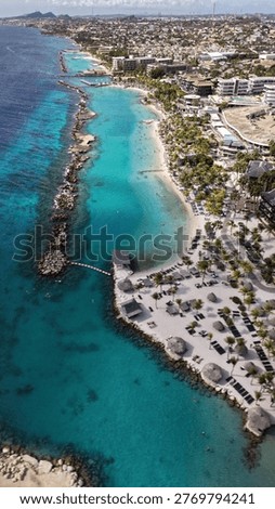 Panoramic aerial perspective of Mambo Beach and the Sea Aquarium area. Stunning drone flight over the crystal clear water and tropical tourist district in Curacao.
