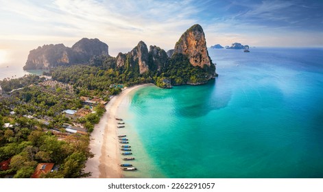 Panoramic aerial view of the beautiful Railay beach, Krabi, Thailand, lush rain forest and emerald sea during morning sunrise without people - Shutterstock ID 2262291057