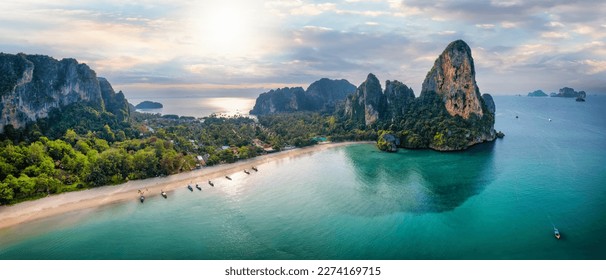 Panoramic aerial view of the beautiful Railay beach, Krabi, Thailand, lush rain forest and emerald sea during morning sunrise without people - Shutterstock ID 2274169715