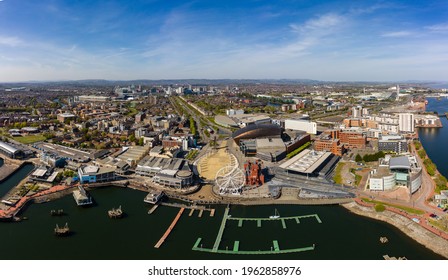 Panoramic aerial view of Cardiff Bay on a sunny day with the city centre in the background.