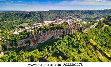 Panoramic aerial view of Civita di Bagnoregio from a flying drone around the medieval city, Italy