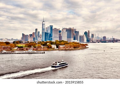 Panoramic and aerial view of downtown Manhattan Skyline and Hudson River. Morning scene after rain, with most cloudy sky. NYC Boat Tours and Sightseeing Cruise sailing in the river  - Shutterstock ID 2015915855