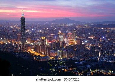 Panoramic aerial view of Downtown Taipei City at dusk, with Taipei 101 Tower in Xinyi Commercial District ~A romantic evening in Taipei, capital city of Taiwan, with dramatic rosy afterglow in the sky