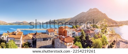 Panoramic aerial view of Egirdir lake and town in Isparta region. Real estate and houses. Calm turquoise and scenic coast of national park in Turkey