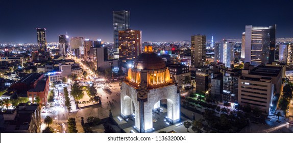 Panoramic aerial view of the famous monument to the revolution at night illuminated with the lights of the city