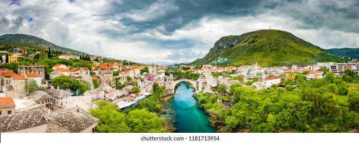 Panoramic aerial view of the historic town of Mostar with famous Old Bridge (Stari Most), a UNESCO World Heritage Site since 2005, on a rainy day with dark clouds in summer, Bosnia and Herzegovina