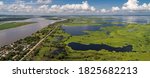 Panoramic aerial view of impressive Magdalena River landscape with blue sky, white clouds and village on a sunny day