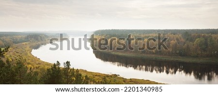 Panoramic aerial view of the majestic pine forest and bends of Daugava river in autumn. Daugavas loki nature park, Latgale, Latvia. Ecology, ecotourism, recreation, travel destinations, landmark