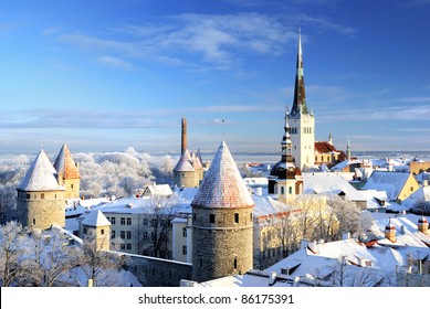 Panoramic Aerial View Of The Old Town Of Tallinn, Estonia. St. Olaf's Church, Fortress Towers, Snow-covered Roofs And Spires. Winter, Christmas Vacations, Travel Destinations, Sightseeing, Culture