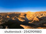 Panoramic aerial view on picturesque Azat reservoir and Eranos mountain at bright sunny evning sunset. Lake with blue water in arid area and Yeranos mountains range. Beautiful landscape. Armenia