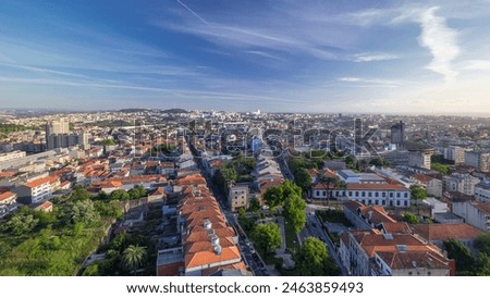Panoramic aerial view over Rooftops of Porto's old town on a warm spring day timelapse before sunset time with cloudy sky, Porto, Portugal