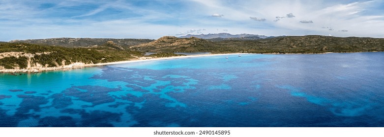 Panoramic aerial view of the Plage de Balistra and the translucent turquoise Mediterranean sea on the south east coast of the island of Corsica - Powered by Shutterstock