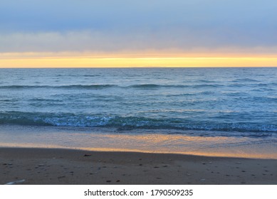 Panoramic Aerial View From A Sandy Baltic Sea Shore After The Rain At Sunset. Golden Sunlight, Colorful Glowing Clouds. Idyllic Seascape. Ventspils, Latvia