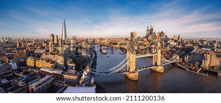 Panoramic aerial view of the skyline of London with Tower Bridge, River Thames and the City skyscrapers during sunrise