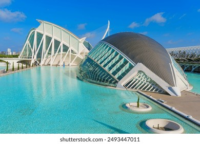 Panoramic aerial view of the stunning architectural features of the City of Arts and Sciences, set against the azure sky and serene waters in Valencia, Spain.