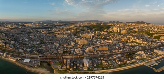 Panoramic Aerial View Of Train Line Cutting Through Sprawling Coastal Town