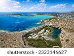 Panoramic aerial view of the Vouliagmeni lake and beach in the background in south Athens, Greece, popular retreat for tourists and locals