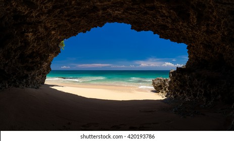 Panoramic amazing view from cave to the tropical beach with azure sea, blue sky and sands beach / Tropical beach Bali / Indonesia
					
