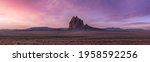 Panoramic American Nature Landscape View of the Dry Desert and Rugged Rocky Mountains. Colorful Sunrise Sky Art Render. Taken at Shiprock, New Mexico, United States.