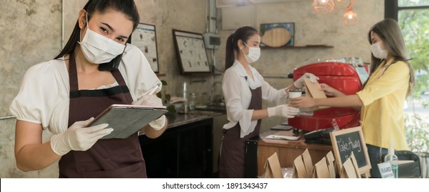 Panoramic Asian Waitress Take Order From Mobile Phone For Takeout Or Curbside Pickup Orders While City Lockdown. They Wear Face Mask To Prevent From Infection Of Coronavirus COVID-19 Pandemic.