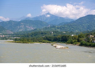 Panoramic background image of the clouds above the mountains, river rapids, green forest at the Dujiangyan Irrigation System, Dujiangyan, Sichuan, China 