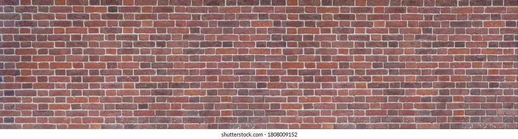 Panoramic background of wide old red brick wall texture. Home or office design backdrop. Home or office design backdrop. High quality photo