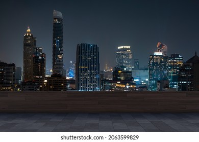 Panoramic Bangkok skyline view, concrete observatory deck on rooftop, night time. Asian corporate and residential lifestyle. Financial city downtown, real estate. Product display mockup empty roof - Shutterstock ID 2063599829