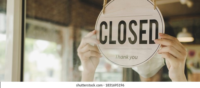 Panoramic banner. friendly waitress woman turning Closed sign board reopen after coronavirus quarantine is over in cafe coffee shop ready to service, restaurant, take away, food and drink concept - Shutterstock ID 1831695196