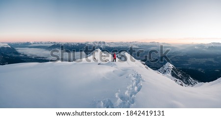 Panoramic banner of man trekking in snow covered mountain. Sport  concept. Silhouette trail hiker in mountain summit background. Hiker on the or alpiniston run training outdoors active fit lifestyle.