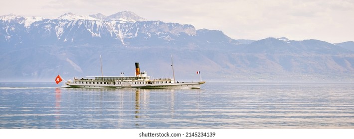 Panoramic banner with steam boat with swiss and french flags floating on Lake Geneva or Lac Leman, Switzerland