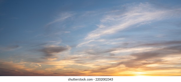 Panoramic beautiful colorful golden hour twilight sky. Beautiful cloud and sky nature background in magic hour. Amazing colorful sky and dramatic sunset evening sky. - Shutterstock ID 2202002343