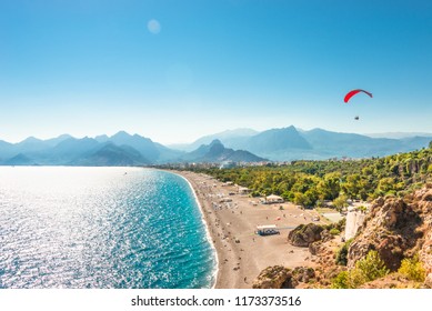 Panoramic bird view of Antalya and Mediterranean seacoast and beach with a paraglider, Antalya, Turkey, Autumn - Powered by Shutterstock