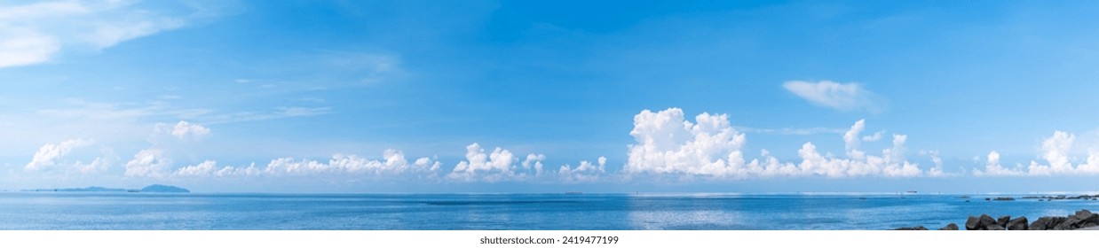 Panoramic blue sky with white fluffy clouds and sea - Powered by Shutterstock