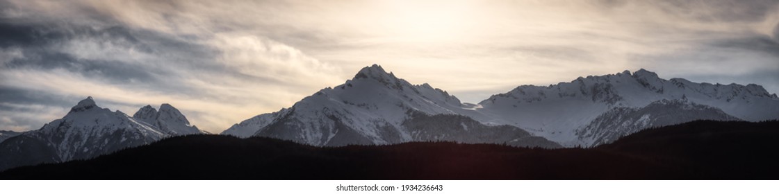 Panoramic Canadian Mountain Landscape View during a cloudy winter day. Taken in Tantalus Lookout near Squamish and Whistler, North of Vancouver, BC, Canada. Background Panorama