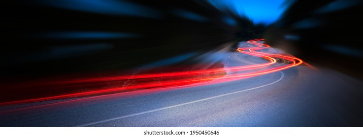 Panoramic - Cars light trails at night in a curve  asphalt road at night, long exposure image - Shutterstock ID 1950450646