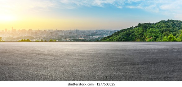 Panoramic city skyline and buildings with empty asphalt road at sunrise - Powered by Shutterstock