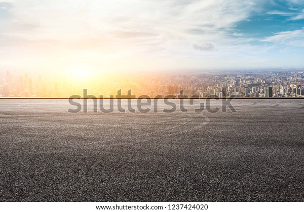 Panoramic city skyline and buildings with empty asphalt\
road pavement 